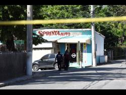 Credit: Nicholas Nunes/Photographer Police cordon off a section of Whitehall Avenue, St Andrew, where Craig Gooden was shot and killed yesterday.