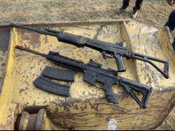 An AK-47 and an M16 rifle, two of the 10 guns found at the Stadium East field in St Andrew. 