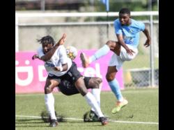 Rohan Beadle (right) of Waterhouse Football Club (right) tries to clear the ball but is blocked by Kenroy Campbell of Cavalier Football Club (left) during their JPL second round football match at the UWI-JFF Captain Horace Burrell Centre Of Excellence on Monday, January 24.