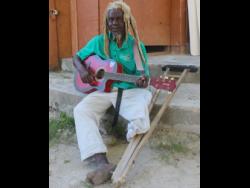 Herman Gordon, also known as ‘Busta One Foot’, performs a song at the The Boat Bar & Cottages in Negril, Westmoreland, last Friday.