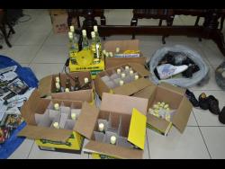 Counterfeit products including rum and shoes that were seized by cops.