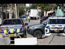 Members of the security forces in Parade Gardens, central Kingston, where a zone of special operations was declared last month.