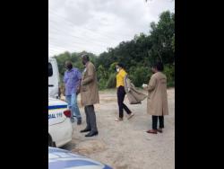 Crime-scene investigators in Tavern Gully, Lawrence Tavern, where Rastafarian Omar Grey was murdered.
