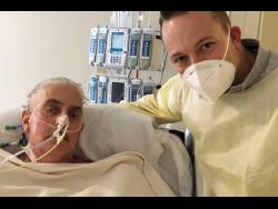 David Bennett Jr (right), stands next to his father’s hospital bed, five days after doctors transplanted a pig heart into Bennett Sr, in a last-ditch effort to save his life. 