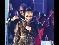 
Shenseea was dripping in ice after she was gifted with a most eye-popping piece of jewellery by London Tyler Holmes, American record producer, rapper and songwriter,at the local launch of her new album ‘Alpha’ at Romeich’s headquarters on Campbell Boulevard, Kingston 11, last night. 
