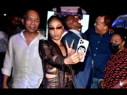 Credit: Kenyon Hemans A maskless Deputy Prime Minister Dr Horace Chang (left), in the background, as entertainer Shenseea takes a selfie at her album launch on Tuesday night. To her right are Finance Minister Dr Nigel Clarke, Health Minister Dr Christopher Tufton and Entertainment Minister Olivia Grange.