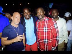 Senator Damion Crawford (centre) is flanked businessman Gary Matalon (left) and Ian Kelly (right), chief financial officer at Derrimon Trading Co, at Wee Pow’s birthday party last Saturday.