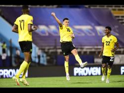 Jamaica’s Ravel Morrison (centre) celebrates his winning goal against Honduras with teammates Devon Williams (right) and Damion Lowe during their FIFA World Cup qualifying football match at the National Stadium last night.