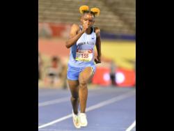 Edwin Allen High School’s Tina Clayton on her way to victory in 11.23 seconds in the Class One Girls 100m final at the ISSA/GraceKennedy Boys and Girls Athletics Championships at the National Stadium last night.