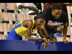 Clarendon College’s Dejanea Oakley (left) celebrates with her brother after claiming the Class One Girls 400m title at the ISSA/GraceKennedy Boys and Girls’ Athletics Championships at the National Stadium last night.