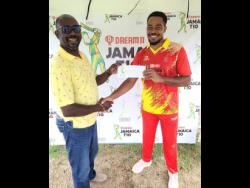 Surrey Risers off-spinner Akim Fraser (right) collects his Man-of-the-Match award from Jamaica Cricket Association (JCA) Second Vice-President Fritz Harrister their win against the Surrey Royals in the Dream11 JCA T10 competition at Sabina Park yesterday.
