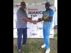Surrey Risers fast bowler Khari Campbell (roght) accepts his Man Of The Match award from Jamaica Cricket Association Director Michael Atterbury for his four wickets against the Surrey Risers in the Dream11 Jamaica T10 competition at Sabina Park in Kingston yesterday.