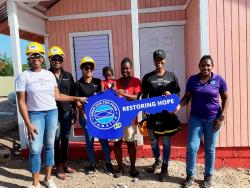Suzette Wilson (third right), one of three house recipients for Mother’s Day from BossMom Network, receives her new house (from left) Diahann Gordon Harrison, Jamaica’s children’s advocate; Karen Phillips, director on the board, FirstRock Foundation; Santanio Husi, operations officer, FirstRock Foundation; Michelle Gordon, founder, BossMom Network; and Marsha Burrell Rose, development and marketing manager, Food For The Poor Jamaica in Curatoe Hill in Clarendon on Tuesday.
