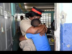 Inspector Tanecia Johnson gets a warm embrace from a student at Mountain View Primary School in St Andrew .