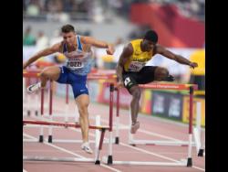 Orlando Bennett (right) of Jamaica clears a hurdle while competing in the Men’s 110m hurdles semi-finals at the World Athletics Championships held at the Khalifa International Stadium in Doha, Qatar, on Wednesday October 2, 2019.