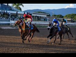 God Of Love (left), ridden by Robert Halledeen, wins the Gerry Skelton Memorial Trophy ahead of One Don(right), over five and a half furlongs at Caymanas Park in St Catherine on Sunday, November 28, 2021.