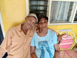 Lloyd Brown cuddles with his wife Joyce at their home in Seaview Gardens, Kingston 11.