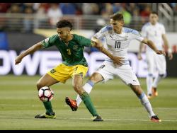 Reggae Boy Michael Hector (left) in action against Uruguay’s Gaston Ramirez in 2016.