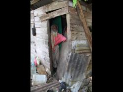 Owen Tapper looks out from his humble abode. He hopes that his luck with turn around as relatives try to build a more sturdy home for him.