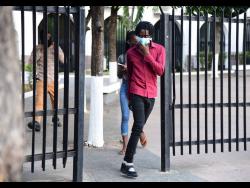 Roshane Williams, one of four alleged members of the Clansman-One Don Gang, departs the Home Circuit Court in Kingston on Thursday. The defence were successful in arguing that there was insufficient evidence. The trial will continue with the remaining 29 defendants.

