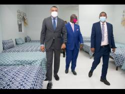 Prime Minister Andrew Holness (left) leads Local Government Minister Desmond McKenzie (centre) and Kingston’s mayor Delroy Williams on a tour of the Desmond McKenzie Transitional Centre for the Homeless, which was opened in downtown Kingston last Friday.