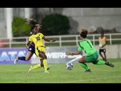 Jamaica’s Jody Brown (second left) in action against Dominican Republic’s Giovanna Dionicio (left) and goalkeeper Odaliana Gomez during their Concacaf Women’s Championship qualifier at Sabina Park on Tuesday, April 12.