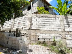 Shooters Hill resident Sophia, whose neighbours Romeo and Saneeka Leachman died tragically in a landslide in 2020, says that since the incident, she has upped her hurricane season preparations by building walls around her property.