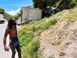 Samaro ‘Dwight’ Reid showing the area of land where his two-bedroom house once stood. 