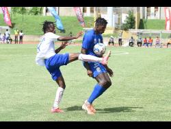 Portmore United’s Demario Phillips puts a boot in to take the ball away from Molynes United’s Sergeni Frankson during their Jamaica Premier League game at Stadium East in Kingston on Saturday, July 10, 2021.