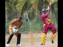 St Catherine CA opener Adrian Bartley (right) plays a shot on his way to a top score of 51 as GC Foster wicketkeeper Aaron Daley Jr looks on during their Jamaica Cricket Association All-Island 50 over encounter at Port Esquivel, St Catherine, on Saturday.