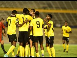 Jamaica’s Reggae Boyz celebrate the opening goal scored by Ravel Morrison in the Concacaf Nations League Group A match against Suriname at the National Stadium last night. Jamaica won 3-1.
