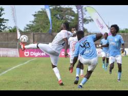 Waterhouse players look on as Mount Pleasant’s Ricardo Morris (left) controls a ball during a Jamaica Premier League game at the Drax Hall Sports Complex in St Ann on Saturday, February 26.