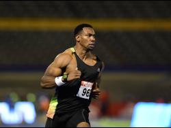 Yohan Blake powers down after winning his 100m heat in 9.93 seconds at the JAAA National Senior Championships at the National Stadium on Thursday night.