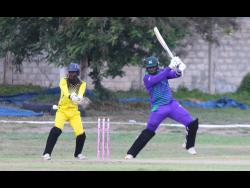 Kensington CC opener Leroy Lugg (right) on the attack during his century knock against St Mary Cricket Association at Kensington Park during the Jamaica Cricket Association 50 Over Competition on Saturday. Wicketkeeper Anthony Walters looks on.