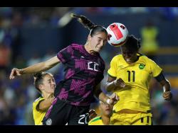 Mexico’s Diana Ordonez (left) and Jamaica’s Khadija Shaw battle for the ball during a Concacaf Women’s Championship match in Monterrey, Mexico on Monday night. Jamaica won 1-0.