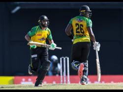 Imad Wasim (left) and Carlos Brathwaite (right) of Jamaica Tallawahs cross for a run during the 2021 Hero Caribbean Premier League match at Warner Park Sporting Complex on Sunday, September 5, 2021.