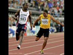 Michael Frater (right) places second in the 100 metres at the 2005 World Championships in Helsinki, Finland. At left is gold medal winner Justin Gatlin of the United States. 