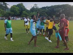 Members of the Faulkland FC team celebrate after gaining promotion to the Jamaica Premier League with their win over Falmouth United in the semi-final of the Jamaica Football Federation Tier Two competition at Drax Hall on Sunday.