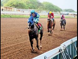 MAHOGANY, ridden by Dick Cardenas, wins the Betting and Gaming Lotteries Commission Trophy, a three-year-old and upwards Stakes race over five and a half furlongs at Caymanas Park yesterday.