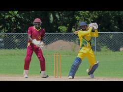 Clarendon Cricket Association’s batsman Albert Gopie (right) scores through the off side on his way to an unbeaten 40 against St Catherine Cricket Association in their JCA T20 Bashment encounter at Sir P Oval in Clarendon on Sunday. Wicketkeeper Ronville Brown watches. Clarendon won the match.