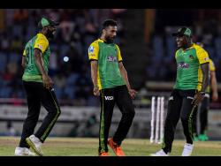 Mohammad Amir (centre), Raymon Reifer (left) and Rovman Powell of Jamaica Tallawahs celebrate the dismissal of Faf Du Plessis of St Lucia Kings during their Caribbean Premier League match at Daren Sammy National Cricket Stadium yesterday.