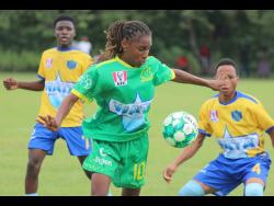  Old Harbour High’s dreadlocked playmaker Shyjah Orridge watches the ball intently during  yesterday’s ISSA daCosta Cup Group M  match  against Tacius Golding High at Port Esquivel. Old Harbour won 3-1.