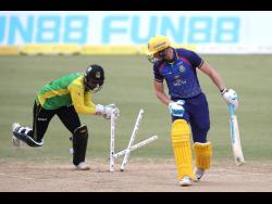 Corbin Bosch (right) of Barbados Royals is stumped by Amir Jangoo off the bowling of Imad Wasim of Jamaica Tallawahs during their Caribbean Premier League (CPL) match at Queen’s Park Oval in Port of Spain, Trinidad and  Tobago, yesterday.