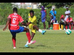 Vere Technical’s Omario Walters (right) rifles a shot at goal, which Kemps Hill’s Kristoff Johnson tries to stop, during the ISSA/Digicel daCosta Cup Group N encounter at Vere Technical High on Friday. Vere won 2-0.