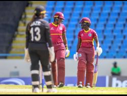 West Indies all-rounder Chinelle Henry (centre) and Kyshona Knight (right) have a mid-pitch conversation during the first one-day international against New Zealand at North Sound in Antigua. New Zealand’s Rashada Williams watches.