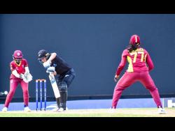 New Zealand’s Maddy Green (centre) plays to the offside during her player-of-the-match performance, while being watched by West Indies’ wicketkeeper Rashada Williams (left) and bowler Karishma Ramharack during their second one-day international (ODI) at the Sir Vivian Richards Stadium in Antigua yesterday. New Zealand won the match to win the series.