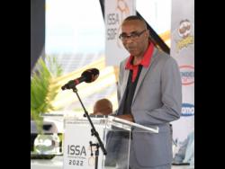 Keith Wellington speaking at the recent launch of the schoolboy football season at the National Stadium recently.