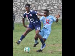St Catherine’s Swayne Blake (left) places Jamaica College’s J’Havier Lynch under pressure during their recent ISSA/Digicel Manning Cup match at Spanish Town Prison Oval, which ended 0-0.
