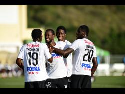 Cavalier’s Kenroy Campbell (second left) celebrates scoring against Harbour View with teammates in their Jamaica Premier League (JPL) match at the UWI/JFF Captain Horace Burrell Centre of Excellence in February.