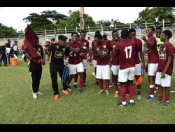 Chapleton Maroons’ coach, Lenworth Hyde (second left), celebrates qualification for the Jamaica Premier League (JPL) with players earlier this year.
